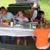 The kids enjoying cake at the picnic.