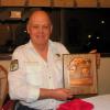 Roy Headley proudly display's his plaque for a photo.